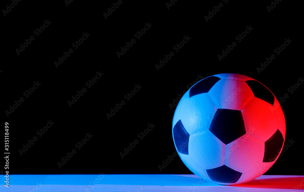 Fototapeta premium Soccer ball isolated on black background. Blue neon Banner Art concept