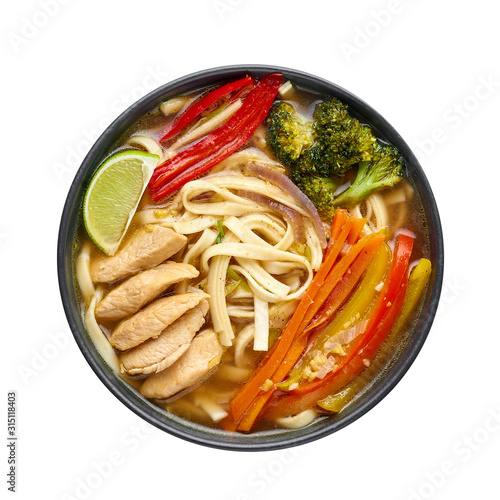 Chicken Thukpa in black bowl isolated at white background. Chicken Thukpa is Tibetan cuisine noodle soup with vegetables and chicken meat. Top view