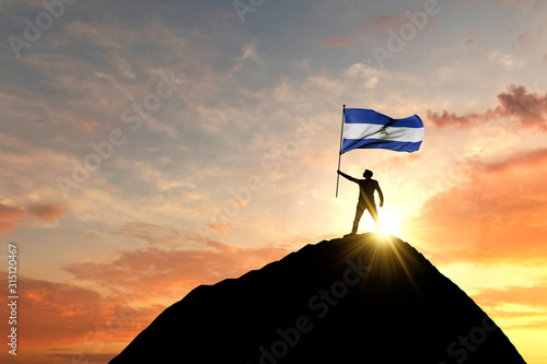 Nicaragua flag being waved at the top of a mountain summit. 3D Rendering