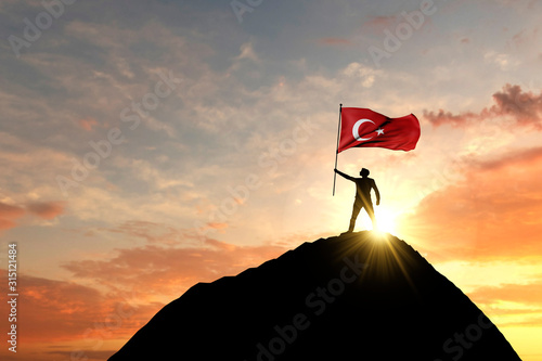 Turkey flag being waved at the top of a mountain summit. 3D Rendering