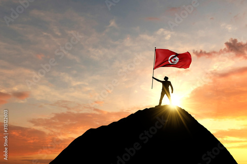 Tunisia flag being waved at the top of a mountain summit. 3D Rendering photo