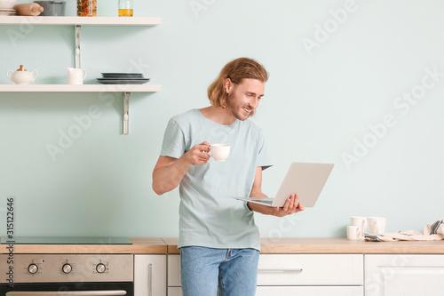 Handsome man with laptop dr...