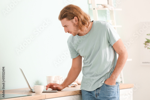 Handsome man with laptop in...