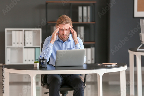 Depressed businessman worki...