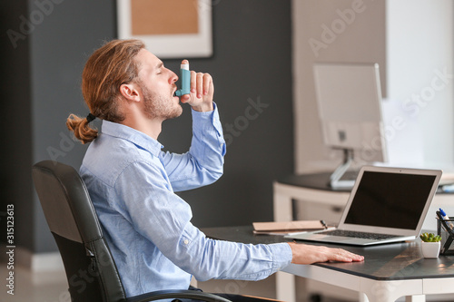 Sick businessman with inhal...