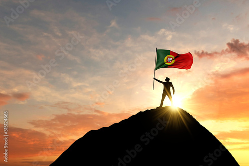 Portugal flag being waved at the top of a mountain summit. 3D Rendering