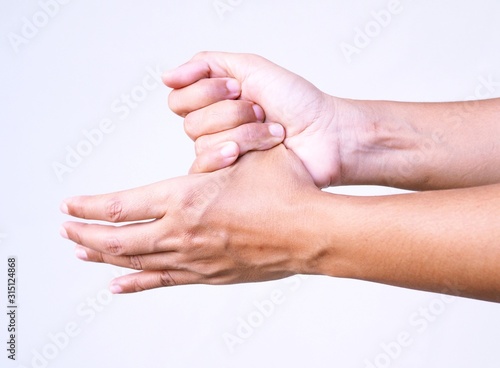 Close up of hand with finger pain and numbness on thumb, isolated on white background. hand pain and cramp.