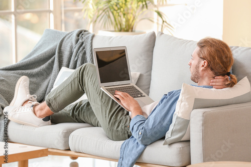 Handsome man with laptop on...