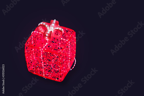 Christmas glowing gift box from pink and white garlands isolated on dark background