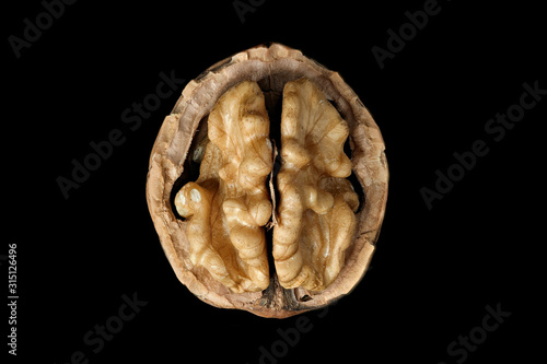 Macro photo of kernel walnut with reflection isolated on a black background 2