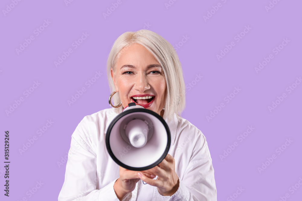 Screaming mature woman with megaphone on color background Screaming mature woman with megaphone on color background