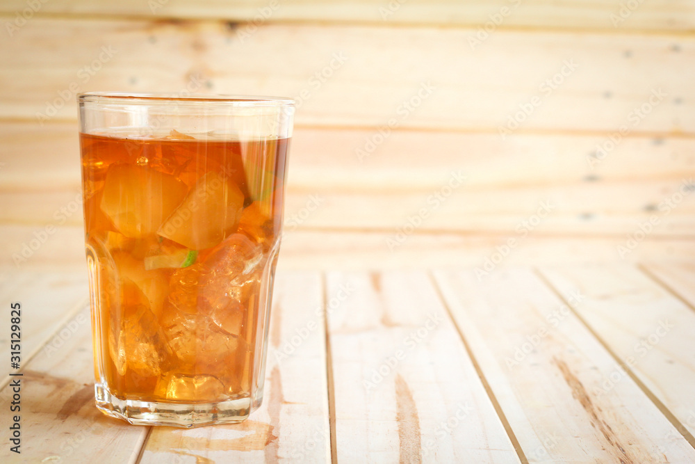 ice tea with slice of lemon in glass on the wooden background ice tea with slice of lemon in glass on the wooden background