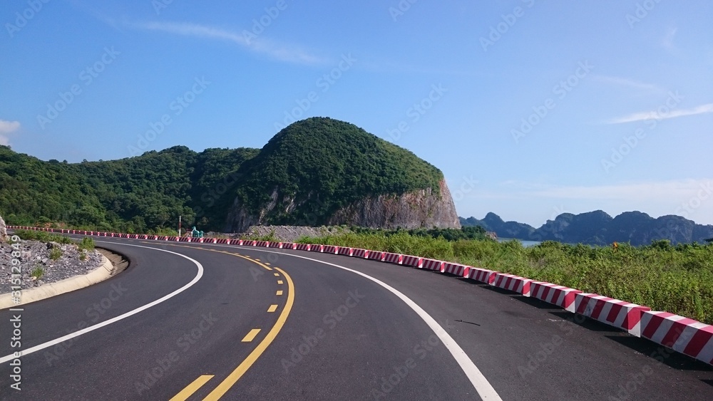 Fototapeta premium Road on the ocean, hills
