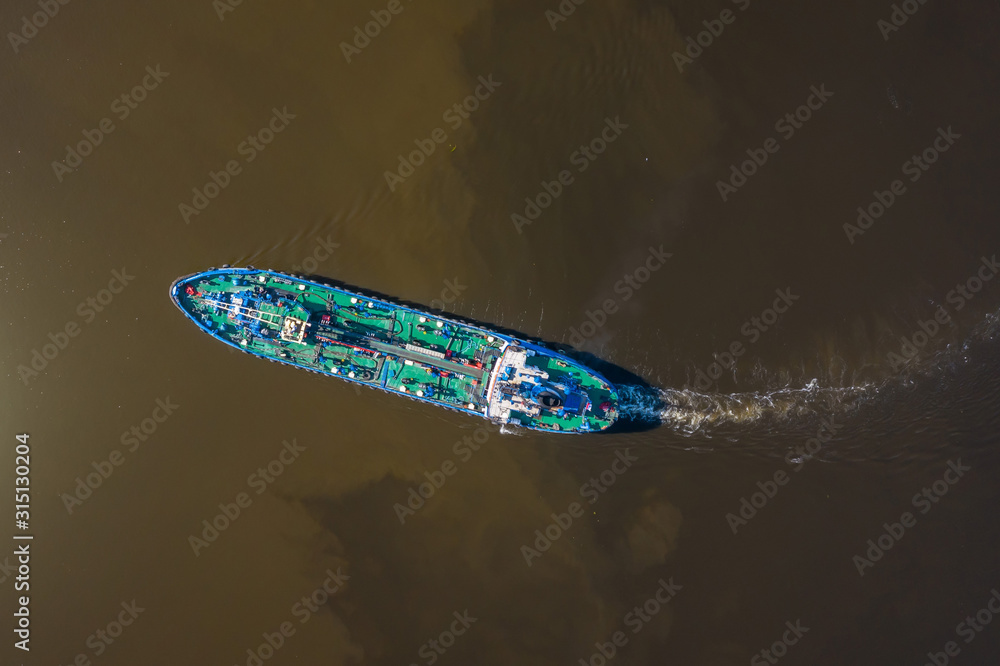 Aerial view of tanker ship sailing on river. Aerial view of tanker ship sailing on river.