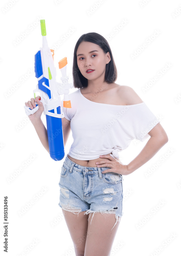 Smiling beautiful Asian girl holding plastic water gun at Songkran festival, Thailand. Modern Beauty fashion women short hair wear White t-shirt happy in Thai ceremony Isolated on white background Smiling beautiful Asian girl holding plastic water gun at Songkran festival, Thailand. Modern Beauty fashion women short hair wear White t-shirt happy in Thai ceremony Isolated on white background