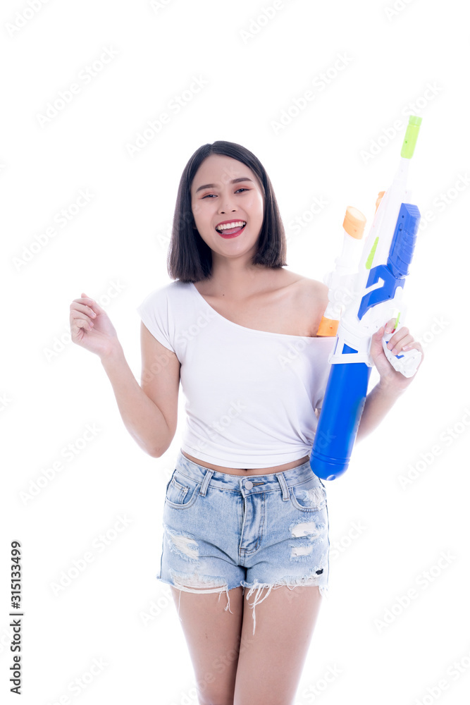 Smiling beautiful Asian girl holding plastic water gun at Songkran festival, Thailand. Modern Beauty fashion women short hair wear White t-shirt happy in Thai ceremony Isolated on white background Smiling beautiful Asian girl holding plastic water gun at Songkran festival, Thailand. Modern Beauty fashion women short hair wear White t-shirt happy in Thai ceremony Isolated on white background