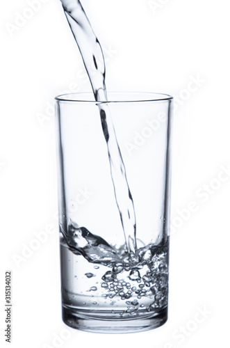 pouring water isolated on a glass on white background