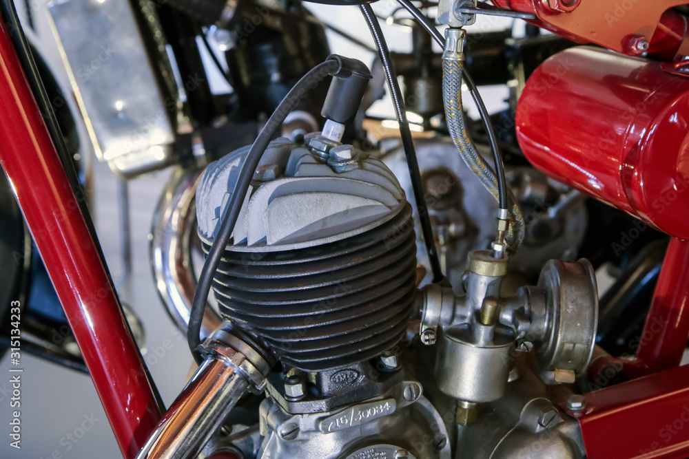 The detail of the old motorcycle with part of the frame, engine, fuel tank and fuel lead. The detail of the old motorcycle with part of the frame, engine, fuel tank and fuel lead.