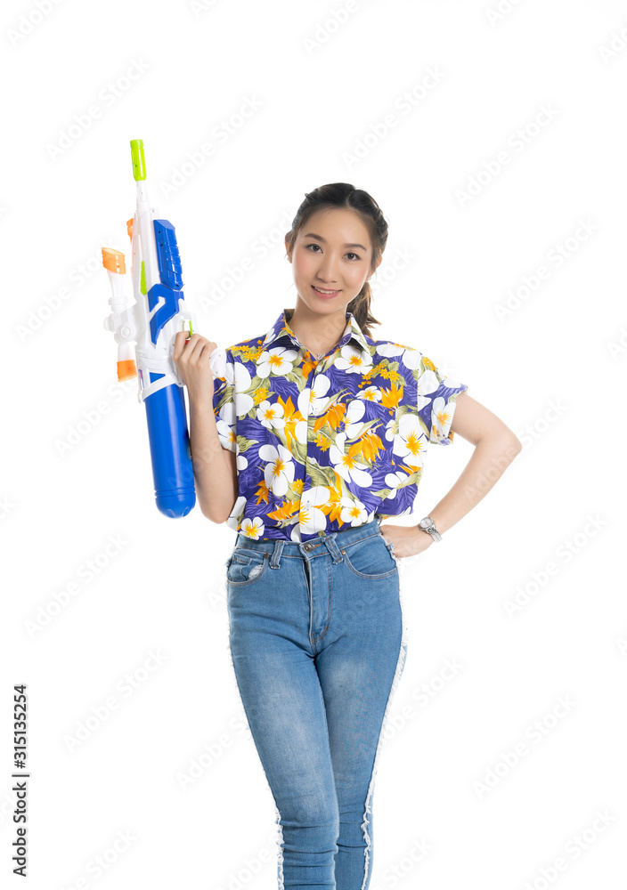 Smiling Asian Thai woman holding plastic water gun at Songkran festival, Thailand. Modern fashion women long hair wear Cloth flowers color happy in Thai ceremony Isolated on white background Smiling Asian Thai woman holding plastic water gun at Songkran festival, Thailand. Modern fashion women long hair wear Cloth flowers color happy in Thai ceremony Isolated on white background