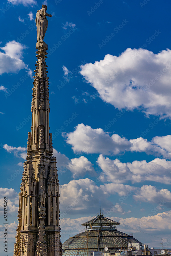 White marble spires on the roof of famous Cathedral Duomo di Milano in Milan, Italy White marble spires on the roof of famous Cathedral Duomo di Milano in Milan, Italy