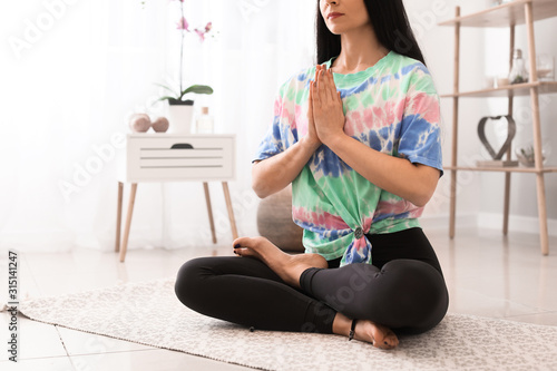 Woman practicing yoga at home