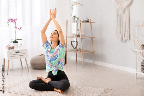 Woman practicing yoga at home