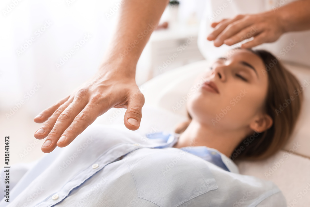 Fototapeta premium Reiki master working with patient