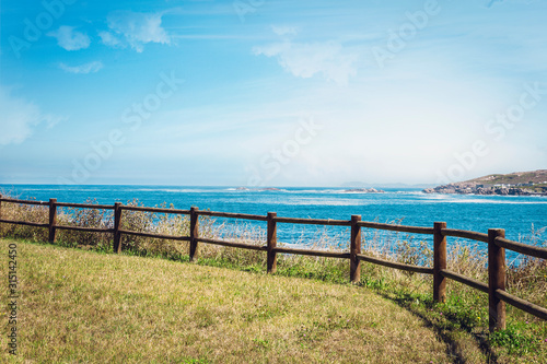 wooden fence at the top of the hill overlooking the sea in a coruna  spain