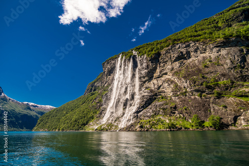 Canvas Print The seven sisters waterfall over Geirangerfjord, located near the Geiranger vill