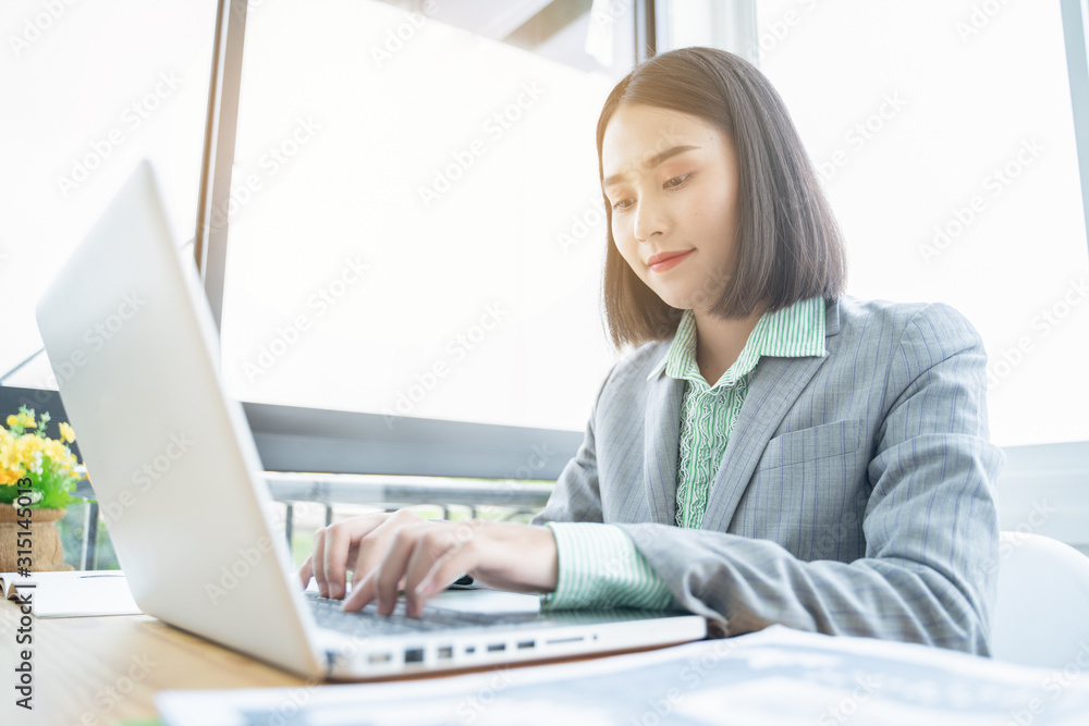 Asian young businessman working with laptop in coffee shop cafe while drinking coffee ,technology or startup business concept, modern office or living room with copy space Asian young businessman working with laptop in coffee shop cafe while drinking coffee ,technology or startup business concept, modern office or living room with copy space