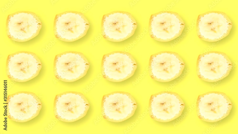 Looping video with rotating banana slices on a yellow background. Looping video with rotating banana slices on a yellow background.
