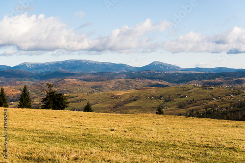 Landscape plain in the mountains. Mountain landscape with residential buildings. © vzwer
