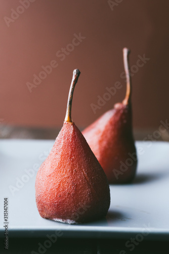 Poached pears with red wine cooked using sous vide technique step by step, ,different steps of preparation, look for other images of the series, the final results are tasty red pears