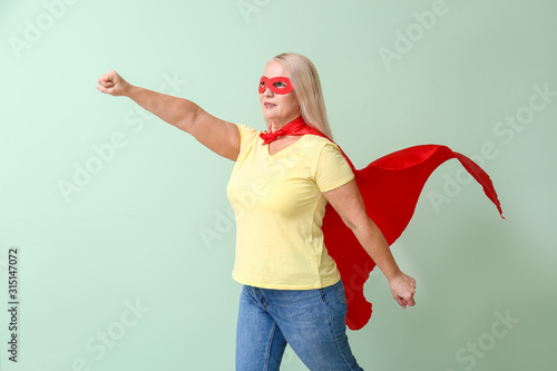Woman in superhero costume ...
