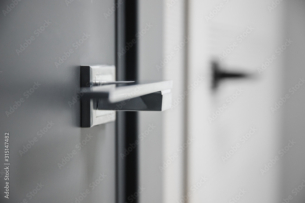 Metal doors knob handle on modern interior - obrazy, fototapety, plakaty 
