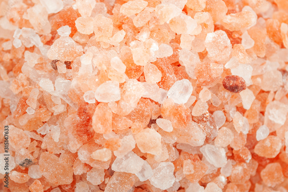 Electrolyte rich food, spa treatment and health benefits due to trace minerals with full frame composition of heap of pink himalayan salt to be used as background with copy space Electrolyte rich food, spa treatment and health benefits due to trace minerals with full frame composition of heap of pink himalayan salt to be used as background with copy space