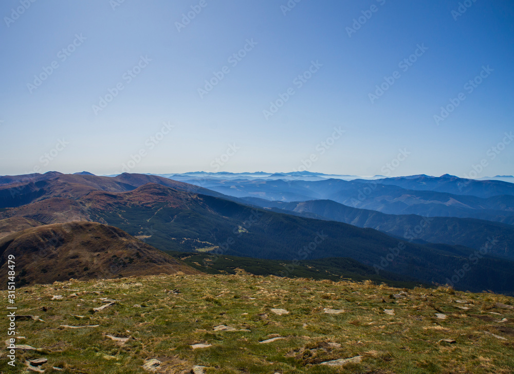 Colorful mountain landscape in the summer mountains. Large hills with blue sky.