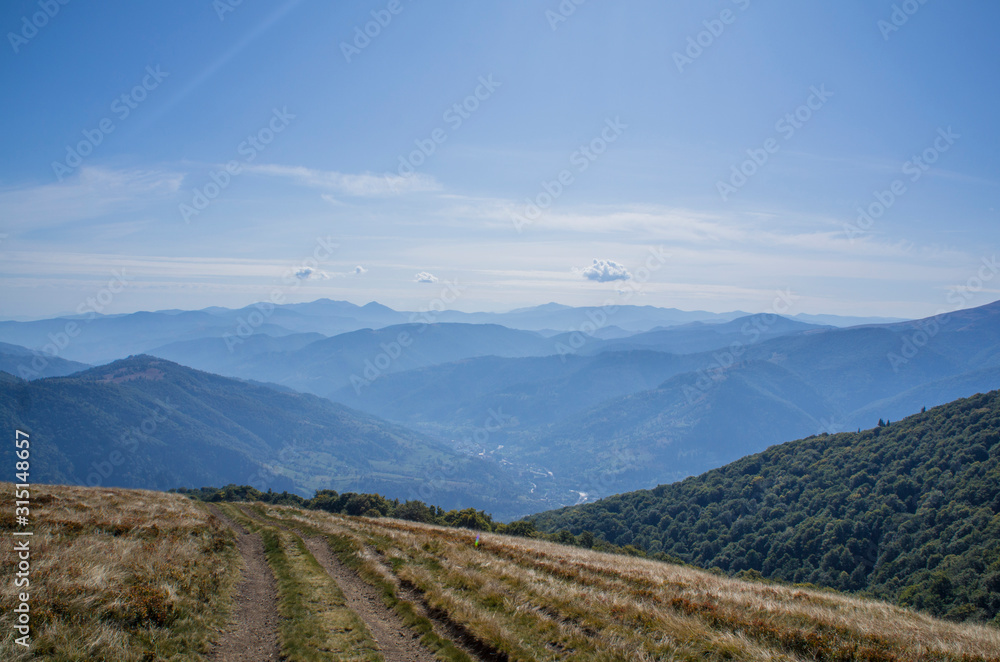 Colorful mountain landscape in the summer mountains. Large hills with blue sky. Colorful mountain landscape in the summer mountains. Large hills with blue sky.