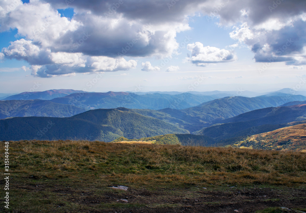 Colorful mountain landscape in the summer mountains. Large hills with blue sky. Colorful mountain landscape in the summer mountains. Large hills with blue sky.