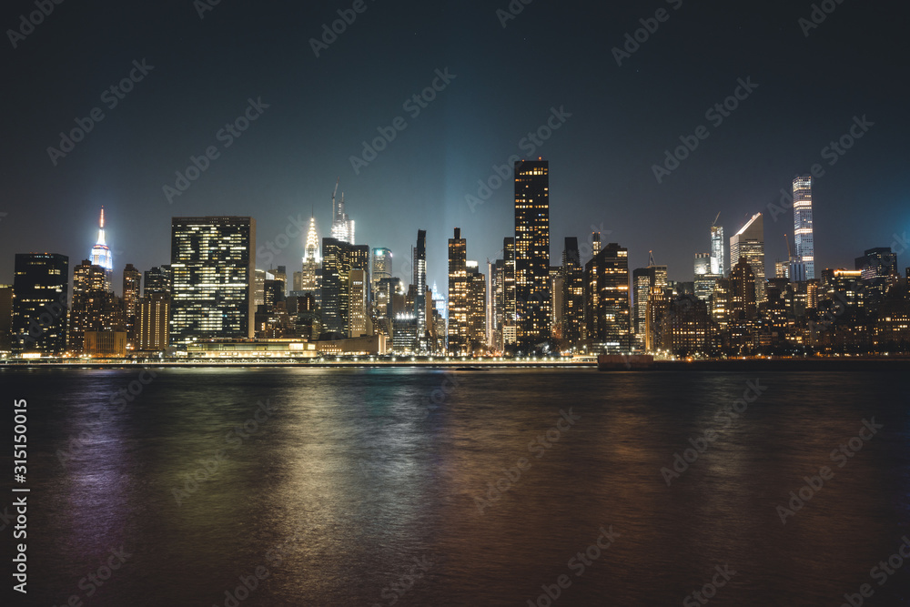 Manhattan Skyline in New York City in the Heart of America during Night Time with Reflection