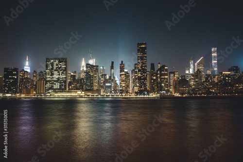 Manhattan Skyline in New York City in the Heart of America during Night Time with Reflection