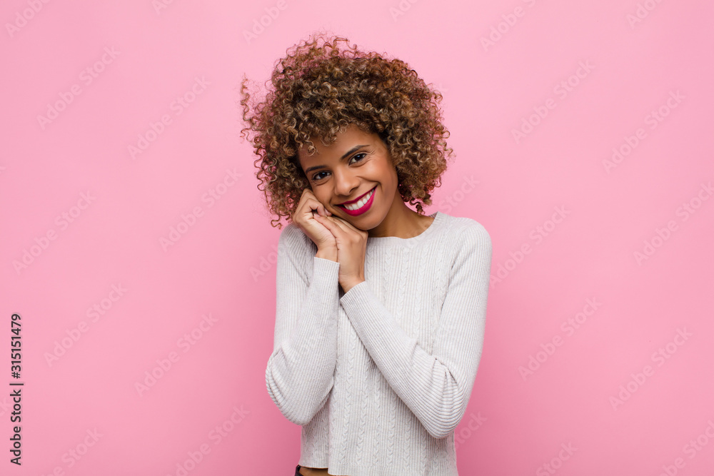Φωτογραφία young african american woman feeling in love and looking cute, adorable and happ