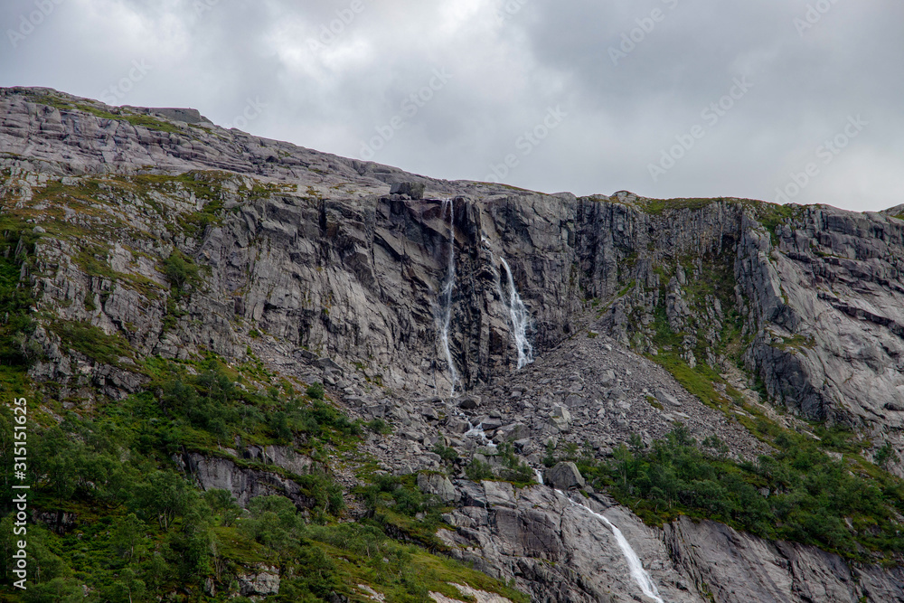 waterfall flowing down from the mountain in norway