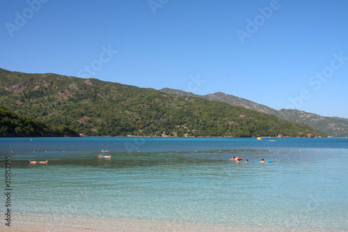 super nice beach on the island in haiti where some bathing.