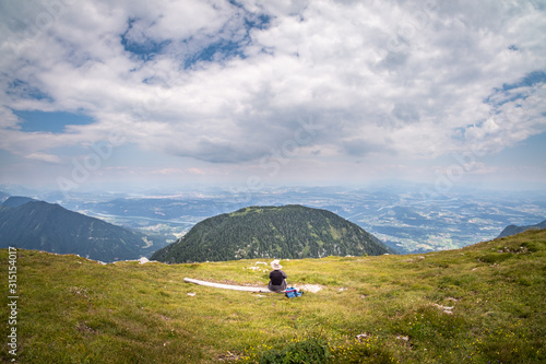 Summit of mountain Hochobir with woman on bench, Carinthia, Austria photo