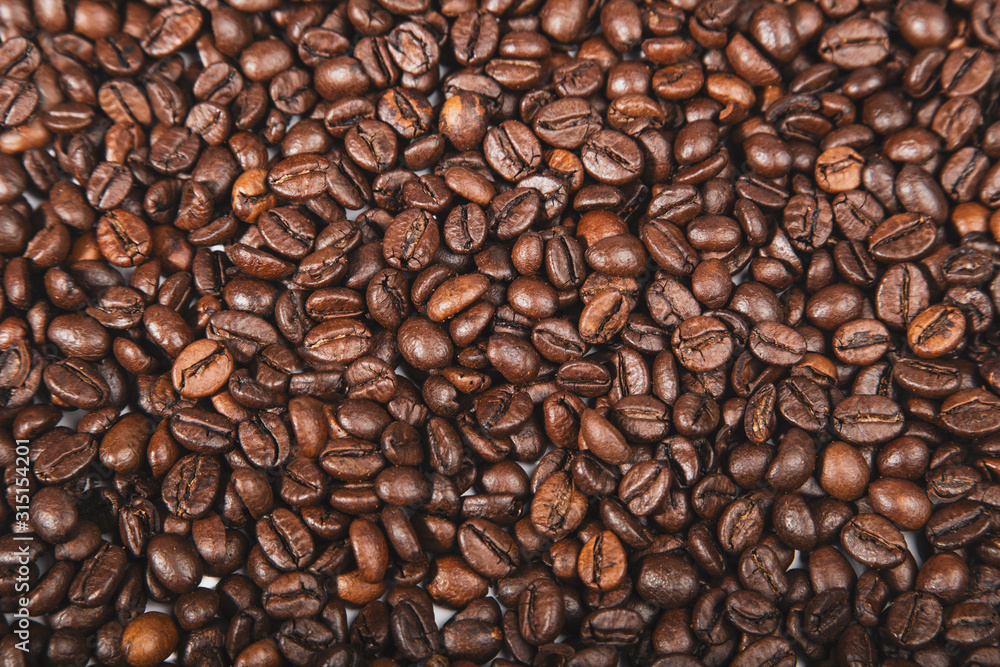 Fresh roasted brown coffee beans, top view of seeds texture as food background for design. Fresh roasted brown coffee beans, top view of seeds texture as food background for design.