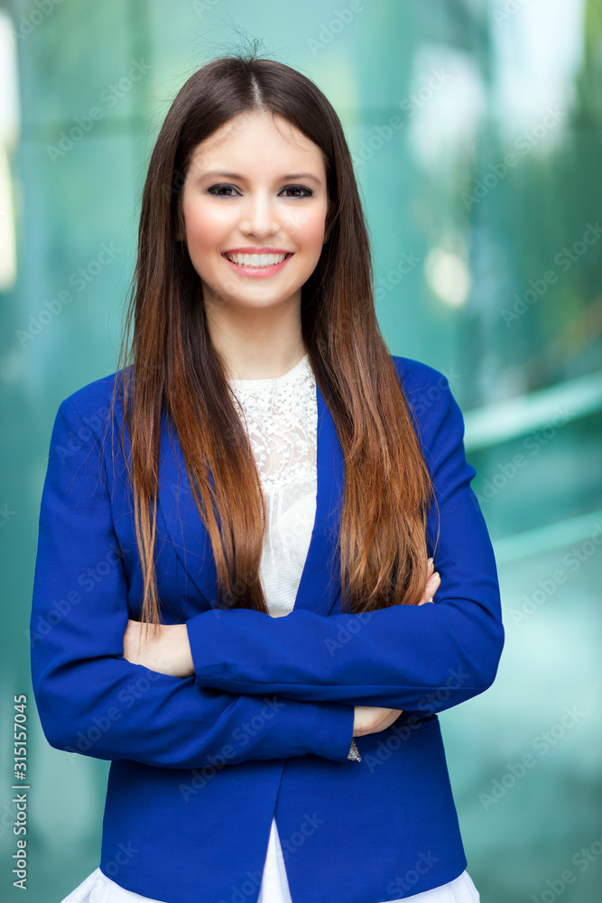 Smiling beautiful businesswoman outdoor in a city setting Smiling beautiful businesswoman outdoor in a city setting