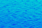 The water surface of the river is bright blue with small waves_