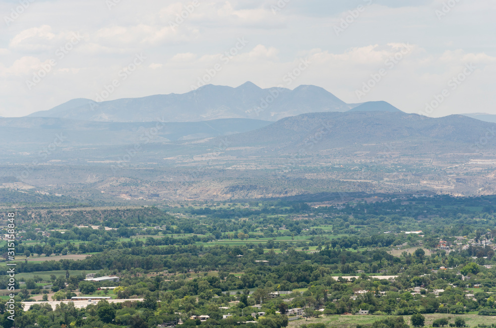 View of sunny Mexican semi-desert landscape View of sunny Mexican semi-desert landscape