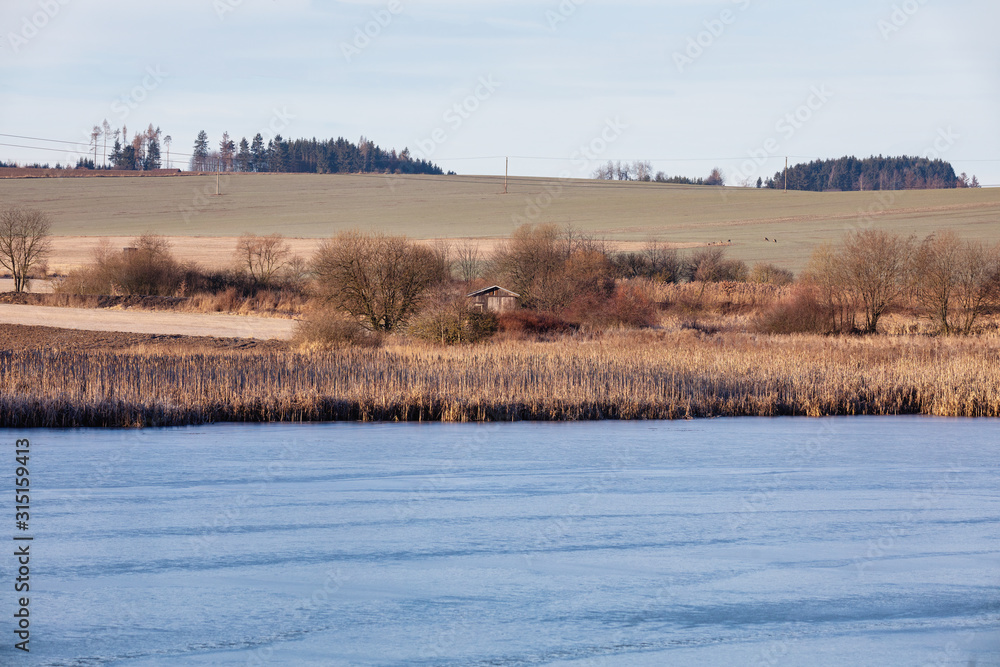 Beautiful winter rural landscape with frozen small pond. Czech beautiful highland vysocina european countryside Beautiful winter rural landscape with frozen small pond. Czech beautiful highland vysocina european countryside